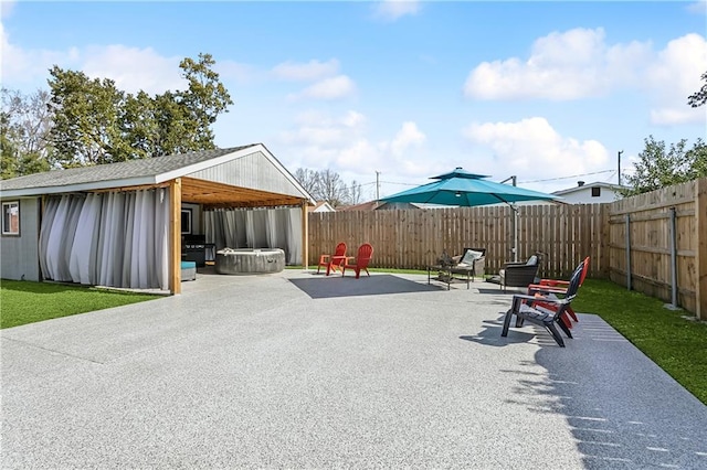 view of patio with a fenced backyard and a jacuzzi