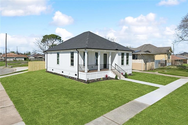 view of front of property with a front yard, crawl space, covered porch, and fence