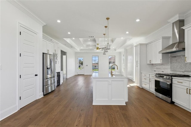 kitchen featuring decorative backsplash, ornamental molding, dark wood-type flooring, stainless steel appliances, and wall chimney range hood