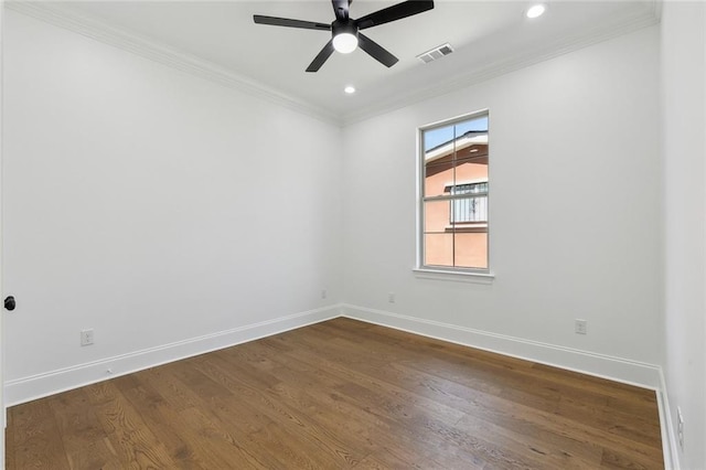 unfurnished room with baseboards, dark wood-type flooring, visible vents, and crown molding