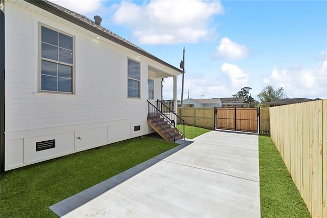 exterior space featuring crawl space, a gate, fence, and a yard