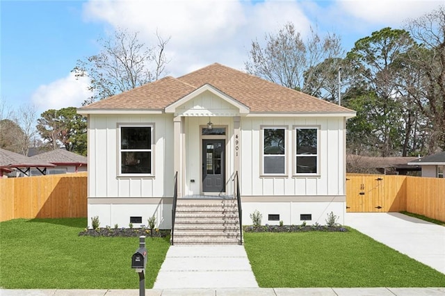 bungalow-style house featuring a shingled roof, crawl space, fence, and board and batten siding