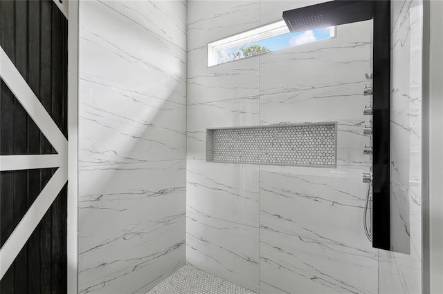 details featuring a marble finish shower