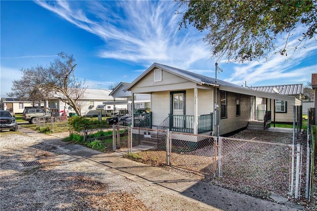 view of front of property featuring a fenced front yard and a gate