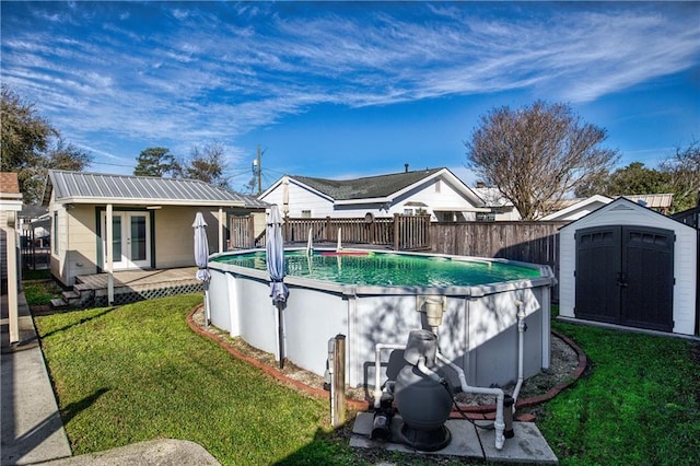 view of swimming pool with a yard, french doors, an outdoor structure, and a fenced in pool