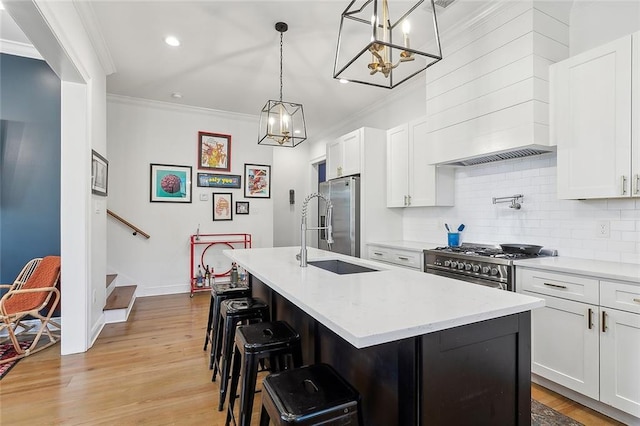 kitchen featuring backsplash, white cabinetry, stainless steel appliances, and ornamental molding