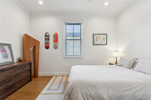 bedroom with recessed lighting, baseboards, wood finished floors, and ornamental molding