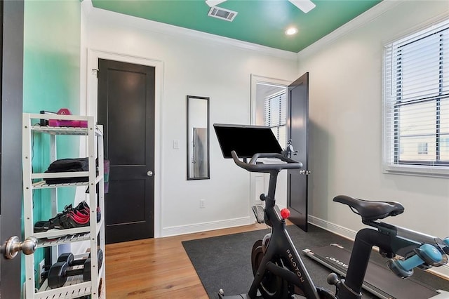 exercise room featuring visible vents, ornamental molding, wood finished floors, recessed lighting, and baseboards