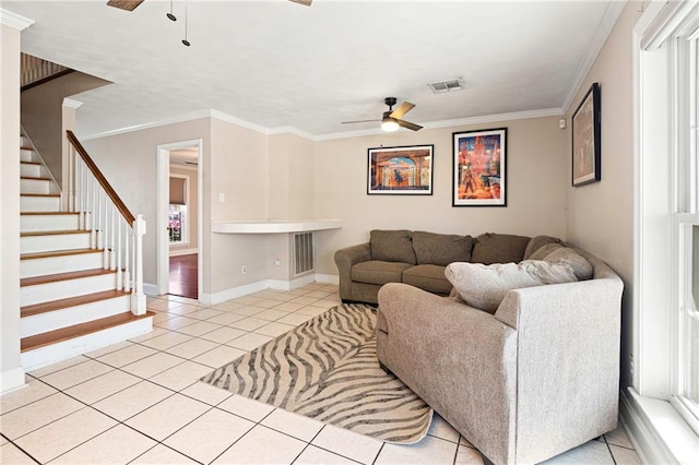 living room featuring a ceiling fan, crown molding, and light tile patterned floors