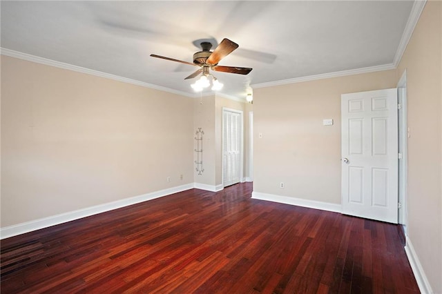 empty room featuring crown molding, ceiling fan, dark wood finished floors, and baseboards