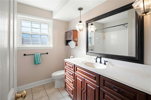 bathroom with toilet, vanity, baseboards, tile patterned floors, and walk in shower