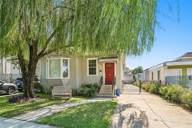 view of front of home featuring driveway, fence, and a gate