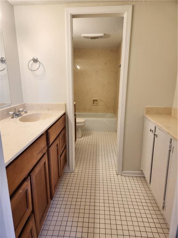 full bathroom featuring toilet, tile patterned floors, bathtub / shower combination, a textured ceiling, and vanity