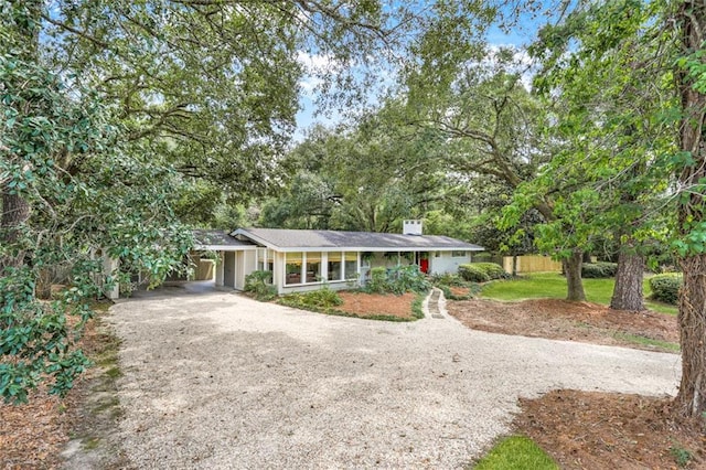 view of front of property featuring driveway and an attached carport