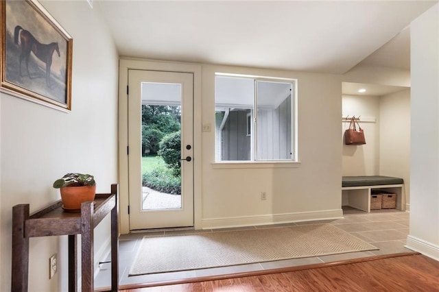 entryway with baseboards and wood finished floors