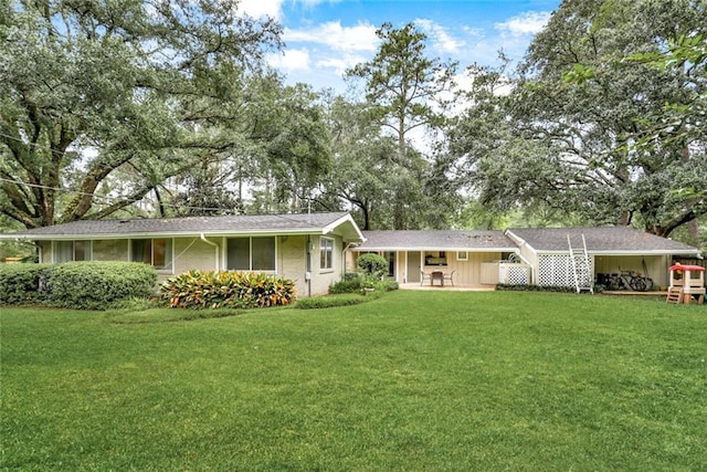 single story home featuring a carport and a front yard