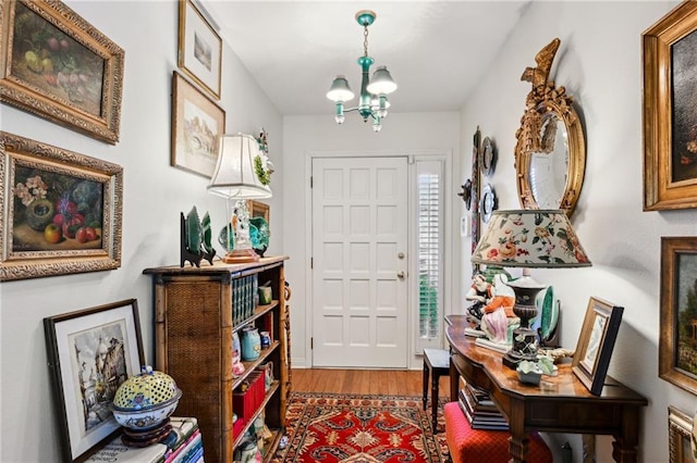 entryway featuring a chandelier and wood finished floors