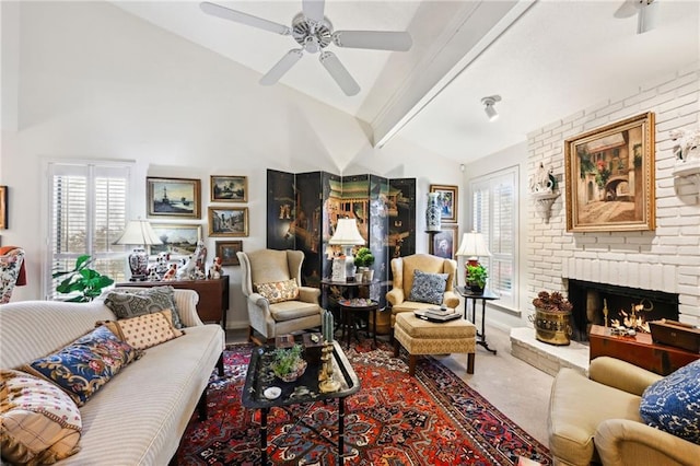 living room featuring a ceiling fan, beamed ceiling, carpet, a fireplace, and high vaulted ceiling