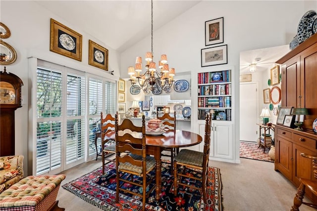 dining area featuring light carpet, high vaulted ceiling, and a notable chandelier