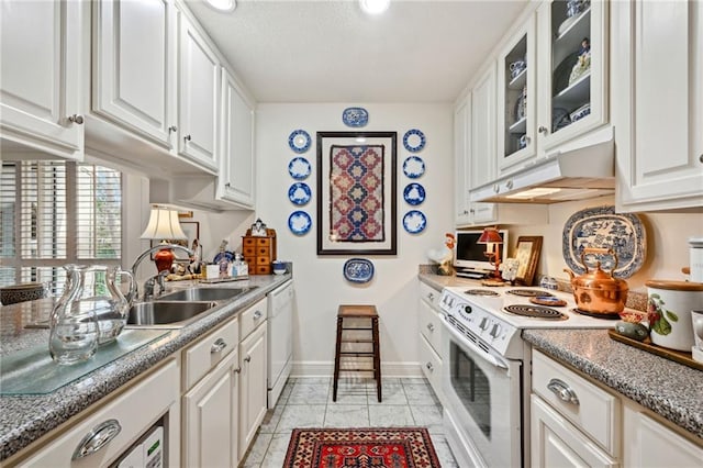 kitchen featuring white appliances, a sink, white cabinetry, and under cabinet range hood