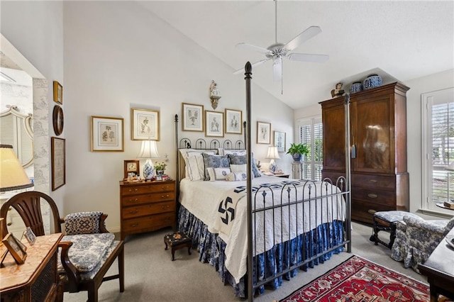 bedroom with light carpet, high vaulted ceiling, and multiple windows