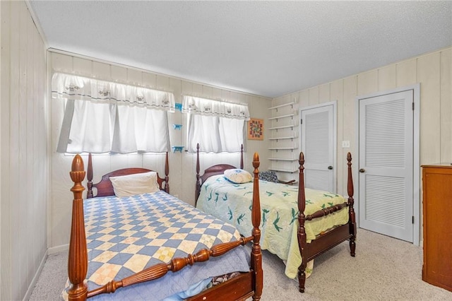 carpeted bedroom featuring a textured ceiling