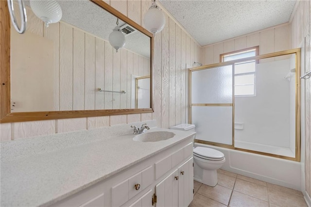 full bathroom featuring vanity, visible vents, a textured ceiling, tile patterned floors, and toilet