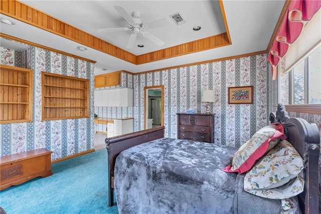 carpeted bedroom featuring a tray ceiling, visible vents, a ceiling fan, and wallpapered walls