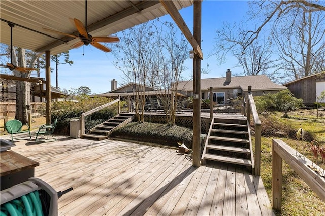 wooden deck featuring stairs and a ceiling fan