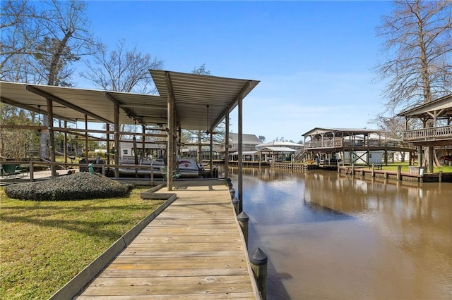 dock area with a water view and a lawn