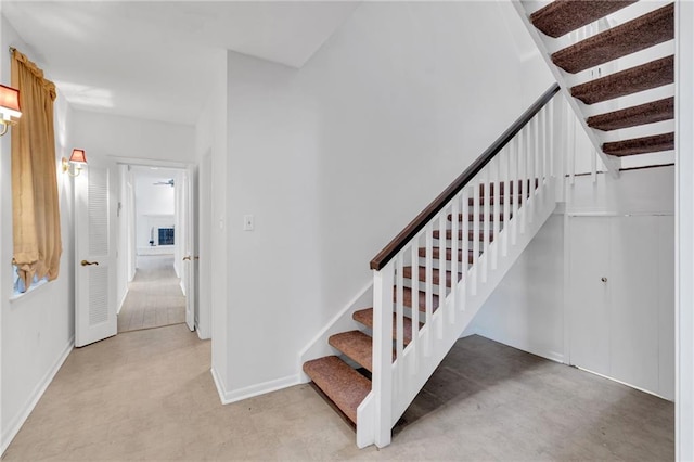 stairway featuring baseboards