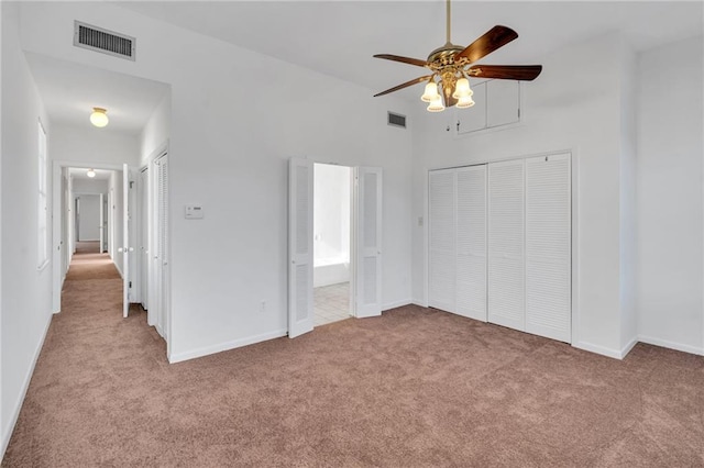 unfurnished bedroom featuring carpet floors, visible vents, and baseboards