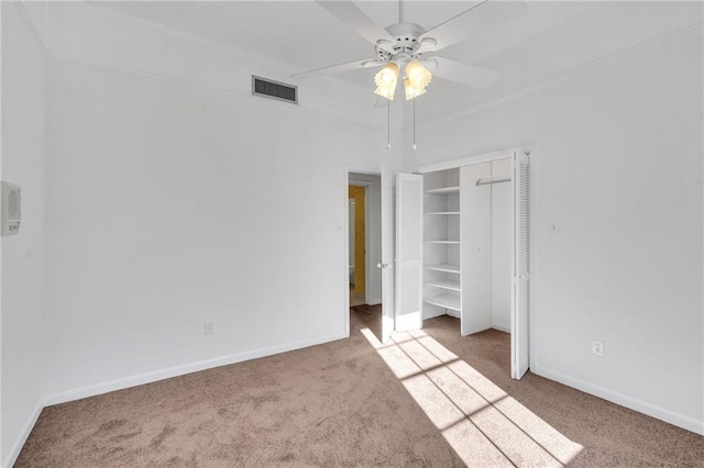 unfurnished bedroom featuring carpet flooring, visible vents, and baseboards