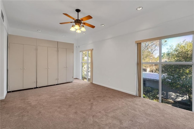 unfurnished bedroom featuring baseboards, carpet floors, a ceiling fan, and recessed lighting