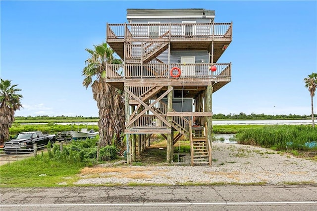 beach home with stairway and a wooden deck