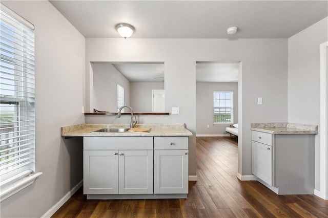 3030 Ridgeway Blvd, New Orleans, LA 70129 - kitchen featuring dark wood-style floors, light countertops, baseboards, and a sink