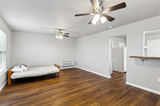 3030 Ridgeway Blvd, New Orleans, LA 70129 - bedroom featuring baseboards, a wall unit AC, freestanding refrigerator, wood finished floors, and a ceiling fan
