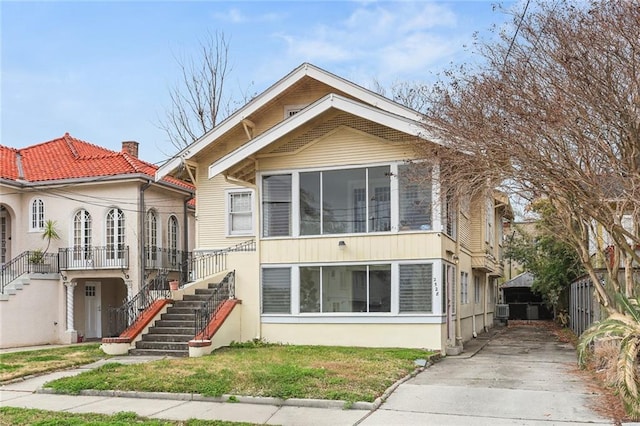 view of front of property with stairway and stucco siding