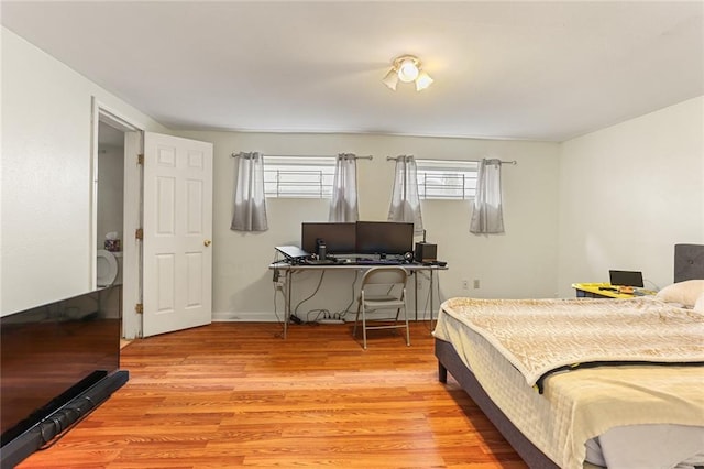 bedroom featuring baseboards and light wood-style floors