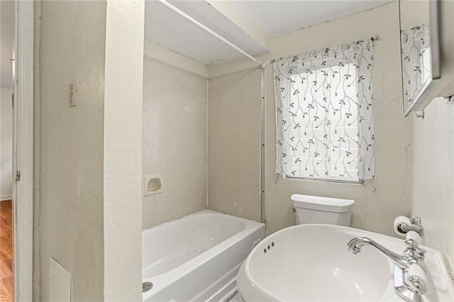 full bathroom with shower / bathing tub combination, a sink, and toilet