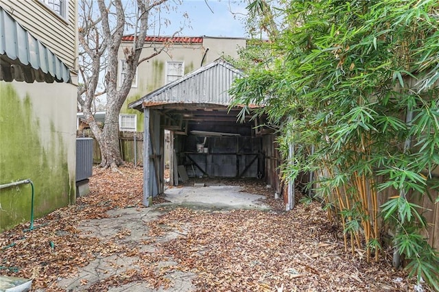 view of yard featuring central AC unit, fence, and an outdoor structure