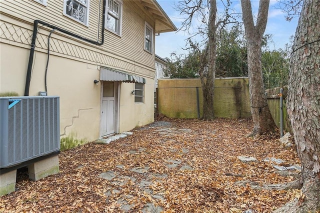 view of yard featuring cooling unit and fence