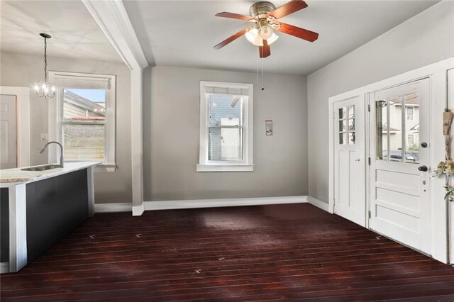 632 S Solomon St, New Orleans, LA 70119 - entryway featuring baseboards, dark wood finished floors, and ceiling fan with notable chandelier
