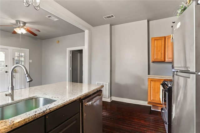 632 S Solomon St, New Orleans, LA 70119 - kitchen featuring dark wood finished floors, appliances with stainless steel finishes, a sink, and visible vents