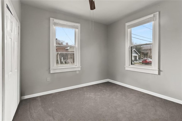 632 S Solomon St, New Orleans, LA 70119 - empty room featuring a healthy amount of sunlight, dark carpet, and baseboards