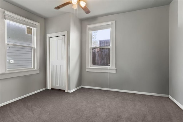 632 S Solomon St, New Orleans, LA 70119 - unfurnished bedroom with dark colored carpet, a closet, ceiling fan, and baseboards