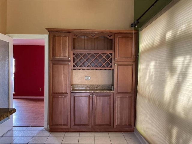 interior space featuring light tile patterned floors and baseboards