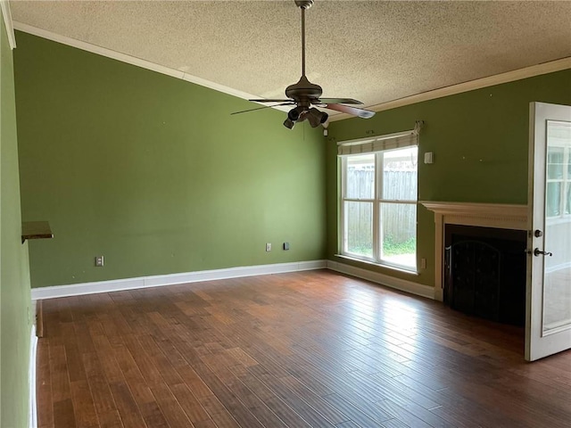 unfurnished living room featuring crown molding, ceiling fan, a fireplace, wood finished floors, and a textured ceiling