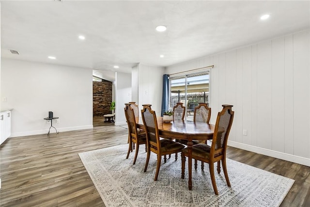 dining space with baseboards, visible vents, wood finished floors, and recessed lighting