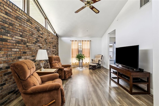 living room with visible vents, a ceiling fan, wood finished floors, high vaulted ceiling, and baseboards